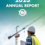 Text reading tbg 2023 annual report and an image of a construction worker holding a piece of paper with a crane in the background