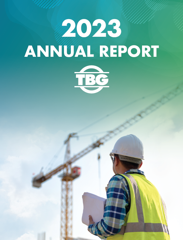 Text reading tbg 2023 annual report and an image of a construction worker holding a piece of paper with a crane in the background